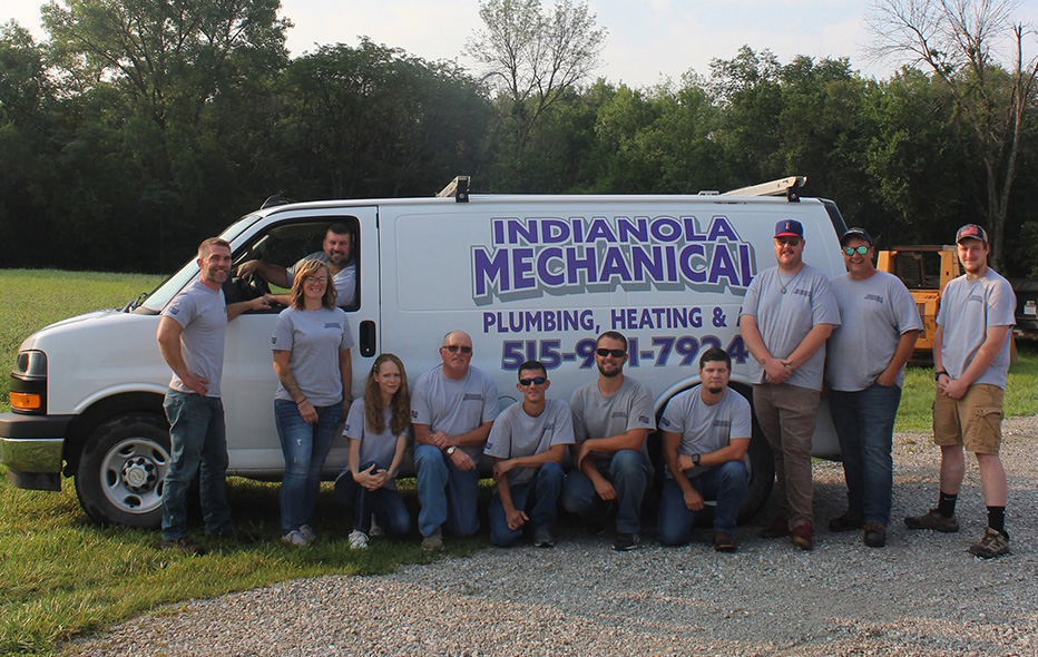 Indianola Mechanical's team posing in front of a van