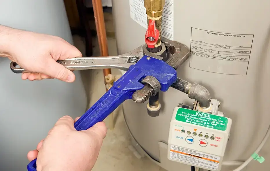 Plumber from Indianola Mechanical working on a water heater
